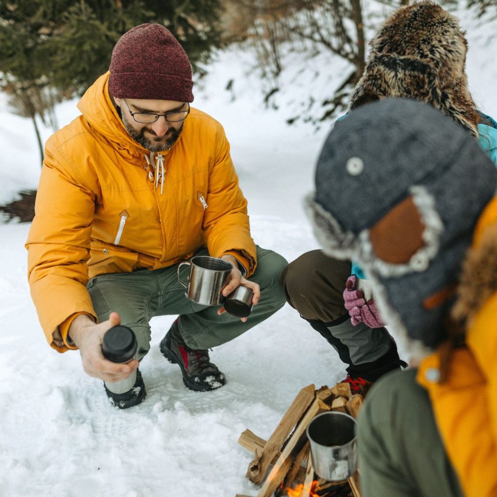 family making breakfast in the snow